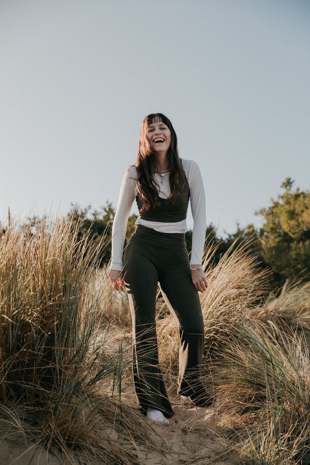Sulli laughing in beach grass