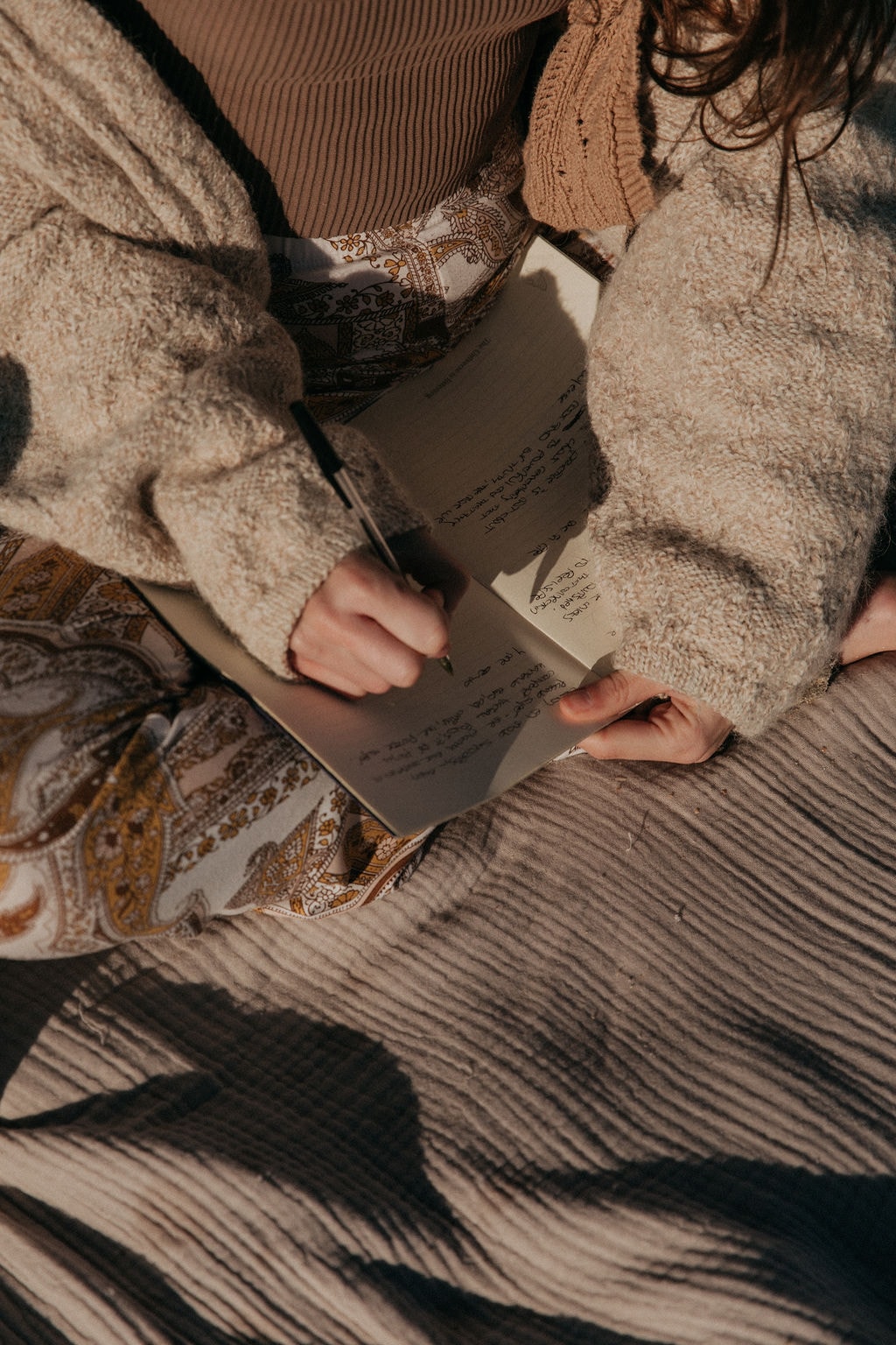 Sulli writing in journal, closeup of hands